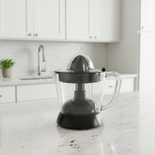 CLEENWOOD CW-577 Electric Citrus Juicer, clear 1-litre capacity jar, showing the rotating reamer cone and the plastic dust cover.